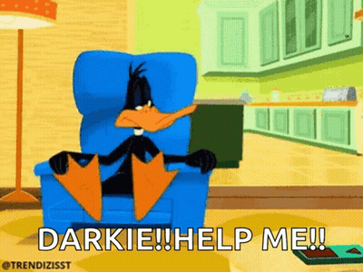 Daffy Duck Sitting In Chair Saying Darkie Help Me GIF
