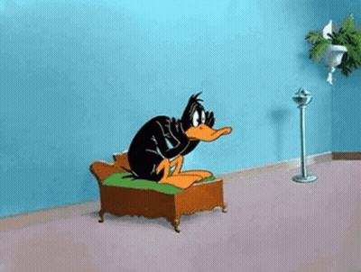 Daffy Duck Sitting On Couch With Fan GIF