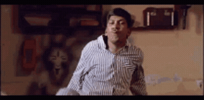 Dancing Man In Striped Shirt Making Funny Face GIF