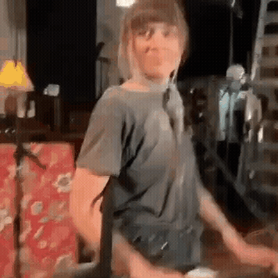 Dancing Woman With Microphone And Red Couch GIF