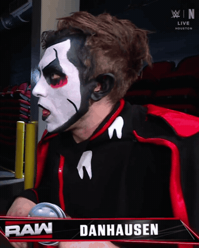 Danhausen Wrestler In Front Of Raw Sign GIF