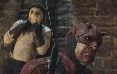 Daredevil Costume Man Next to Masked Man