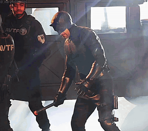 Daredevil Holding Bat In Front Of Police Officer With AVTF GIF