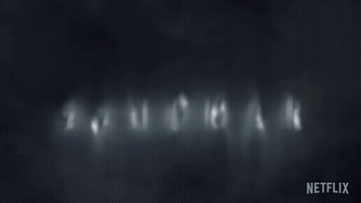 Dark Background With Sandman In White Letters GIF
