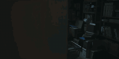 Dark Room With Typewriter And Calculator On Desk GIF