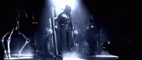 Darth Vader And Emperor Palpatine Standing Next To Each Other In A Dark Room GIF