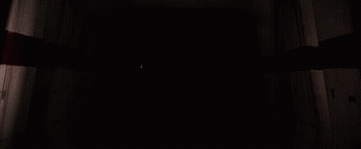 Darth Vader Holding A Red Light Saber In A Dark Room GIF