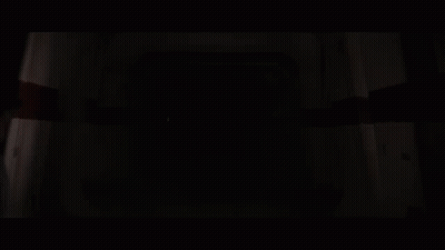 Darth Vader Holding A Red Lightsaber In A Dark Room GIF