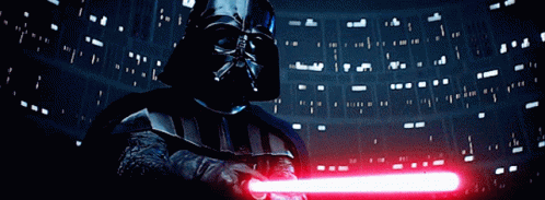 Darth Vader Is Holding A Red Light Saber In Front Of A Dark Background GIF