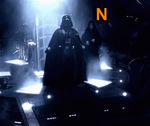 Darth Vader Is Standing In A Dark Room With The Letter N Behind Him GIF