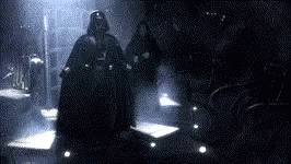Darth Vader Is Standing In A Dark Room With Two People . GIF