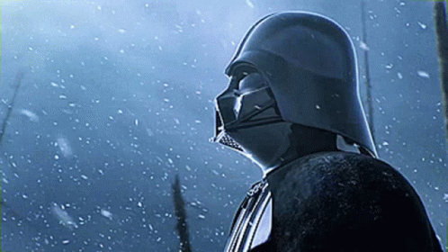 Darth Vader Is Standing In The Snow Wearing His Helmet GIF