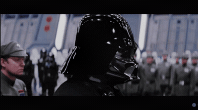 Darth Vader Stands In Front Of A Group Of Soldiers In A Star Wars Movie GIF