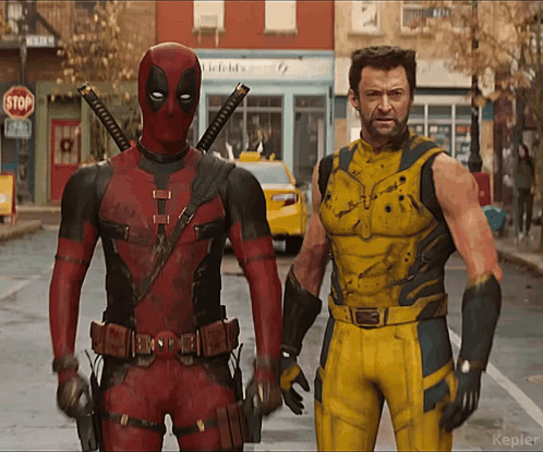 Deadpool And Wolverine Are Standing Next To Each Other On A Street With A Stop Sign In The Background GIF