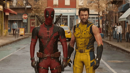 Deadpool And Wolverine Standing Next To Each Other On A City Street GIF