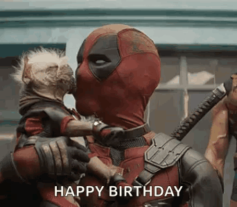 Deadpool Is Holding A Dog In His Arms And Kissing It On The Cheek . GIF