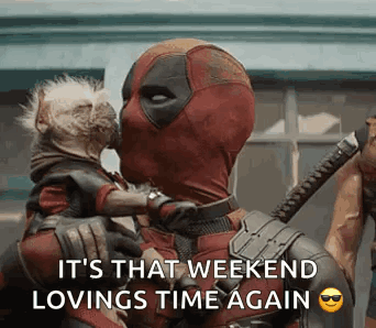 Deadpool Is Holding A Dog In His Arms And Kissing It On The Cheek . GIF