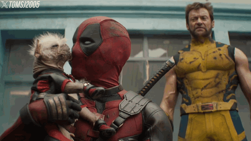 Deadpool Is Kissing A Small Dog While Wolverine Stands Behind Him GIF
