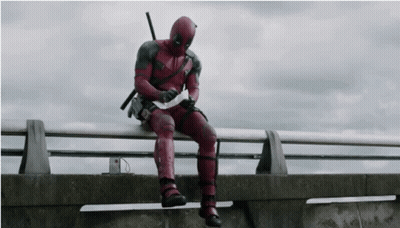 Deadpool Man Sitting On Railing Holding Paper GIF