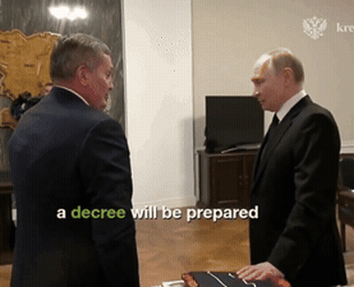 Decree Displayed On Screen Between Two Men GIF