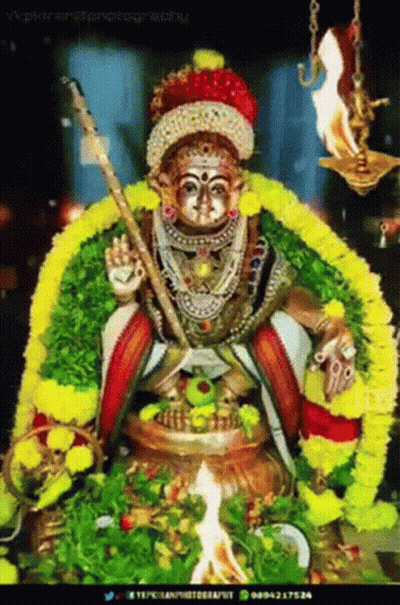 Deity Statue With Sword And Flowers GIF
