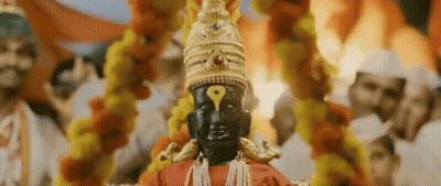 Deity Statue With Yellow Eye And Gold Hat GIF