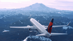 Delta Airline Flying Above Snowy Mountains GIF