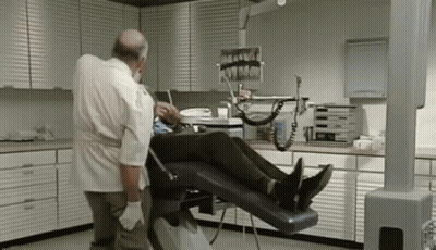 Dentist Examining Patient's Teeth In Dental Chair GIF