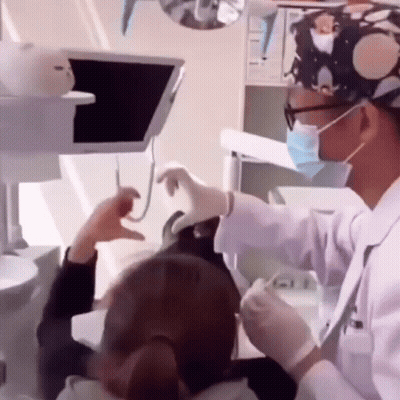 Dentist Examining Woman's Teeth GIF