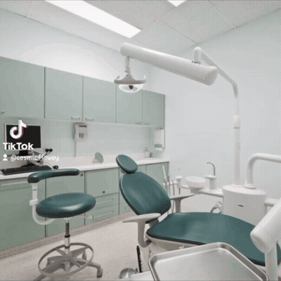 Dentist's Office With Green Chair And Computer On Counter GIF