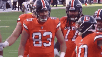 Denver Broncos Football Players Standing On Field GIF