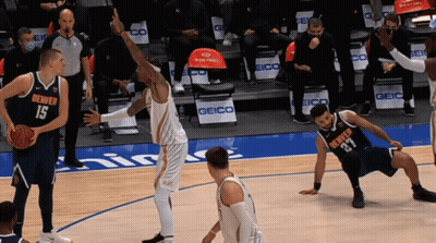 Denver Players 15 And 27 Are Playing Basketball On A Court GIF