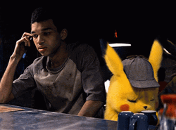 Detective Pikachu Sitting Beside Harry Goodman GIF