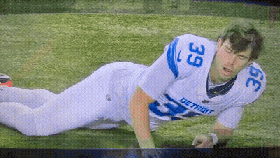 Detroit Football Player Laying On Ground GIF