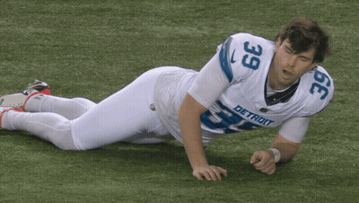Detroit Football Player Laying On Ground GIF
