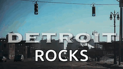 Detroit Rocks Sign Hanging From Street Light GIF