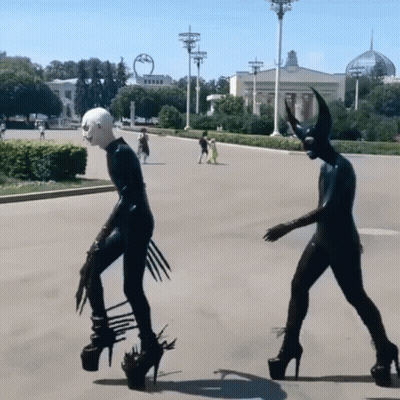 Devil Statue With Horns Walking Down Street GIF