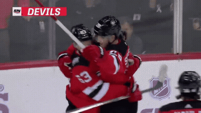 Devils Hockey Players Hugging In Front Of SN Logo GIF