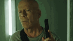 Die Hard Holding A Gun Searching GIF
