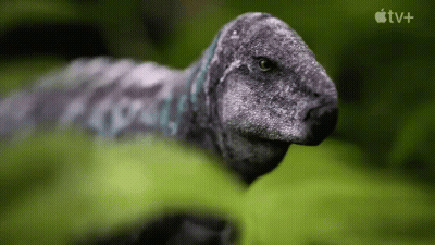 Dinosaur In Grass With Apple TV+ Logo GIF