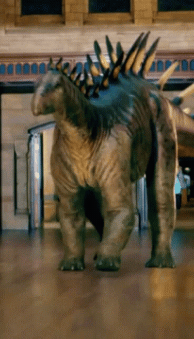 Dinosaur On Wooden Floor Near Brick Building GIF