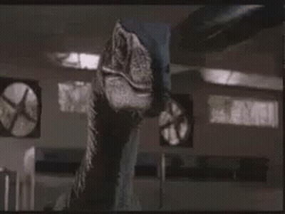 Dinosaur Standing Next To Fan GIF
