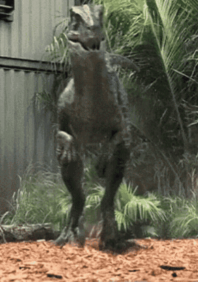 Dinosaur Statue In Front Of Building GIF