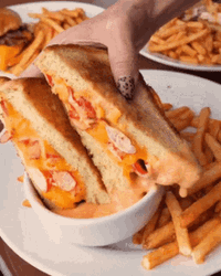 Dipping A Sandwich In Sauce