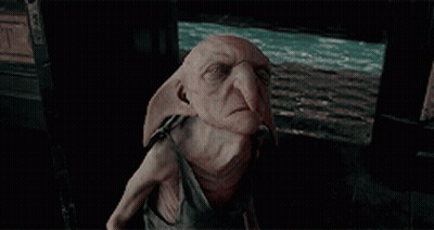 Dobby From Harry Potter Sitting In Dark Room GIF
