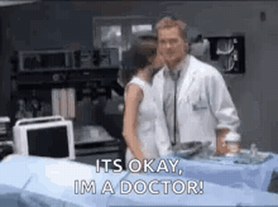 Doctor and Woman Standing in Hospital Room