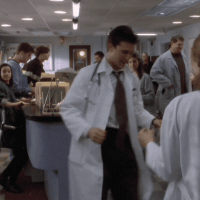 Doctor In Lab Coat Talking To Nurse GIF