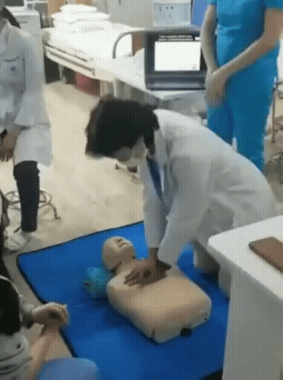 Doctor Practicing On Dummy In Hospital GIF
