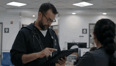 Doctor Talking To Nurse Holding Tablet GIF
