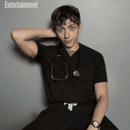 Doctor With Stethoscope In Front Of Poster GIF